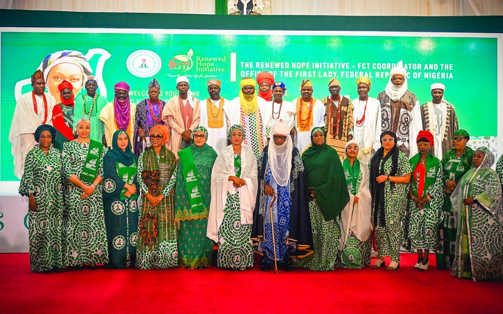 First Lady Senator Oluremi Tinubu, CON, and various dignitaries, traditional leaders, and officials posing for a group photograph on a stage with a green "Renewed Hope Initiative" backdrop.
