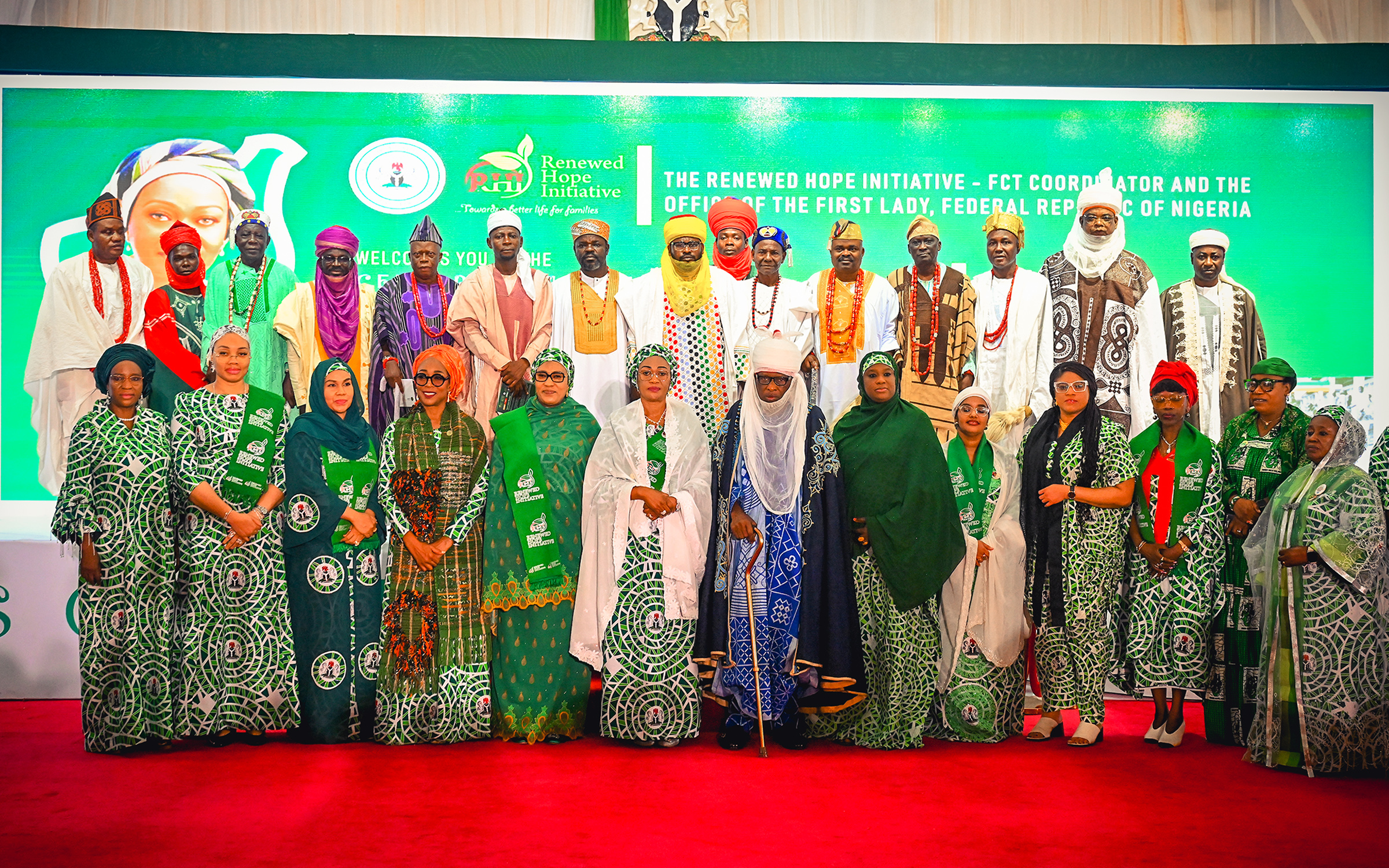 First Lady Senator Oluremi Tinubu, CON, and various dignitaries, traditional leaders, and officials posing for a group photograph on a stage with a green "Renewed Hope Initiative" backdrop.