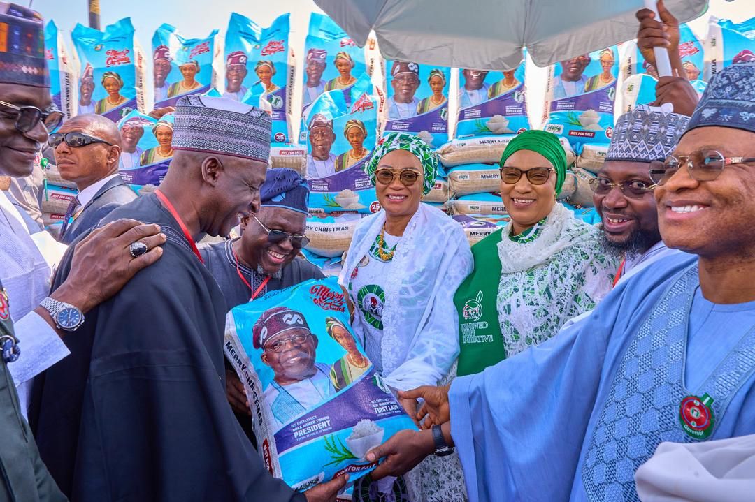 First Lady Senator Oluremi Tinubu, CON, presents food items to beneficiaries during the Renewed Hope Initiative Christmas outreach programme.