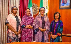 First Lady Senator Oluremi Tinubu, CON, posing for a group photograph with female officials indoors.