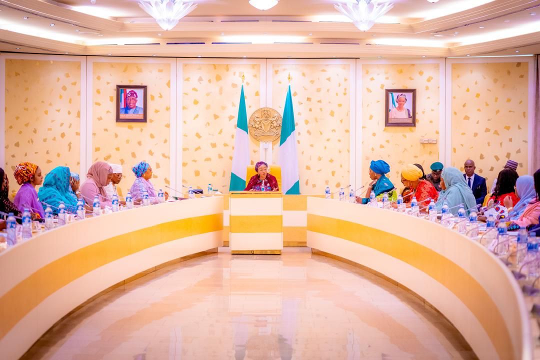 First Lady Senator Oluremi Tinubu, CON, presiding over an official meeting seated at the head of a large conference table.